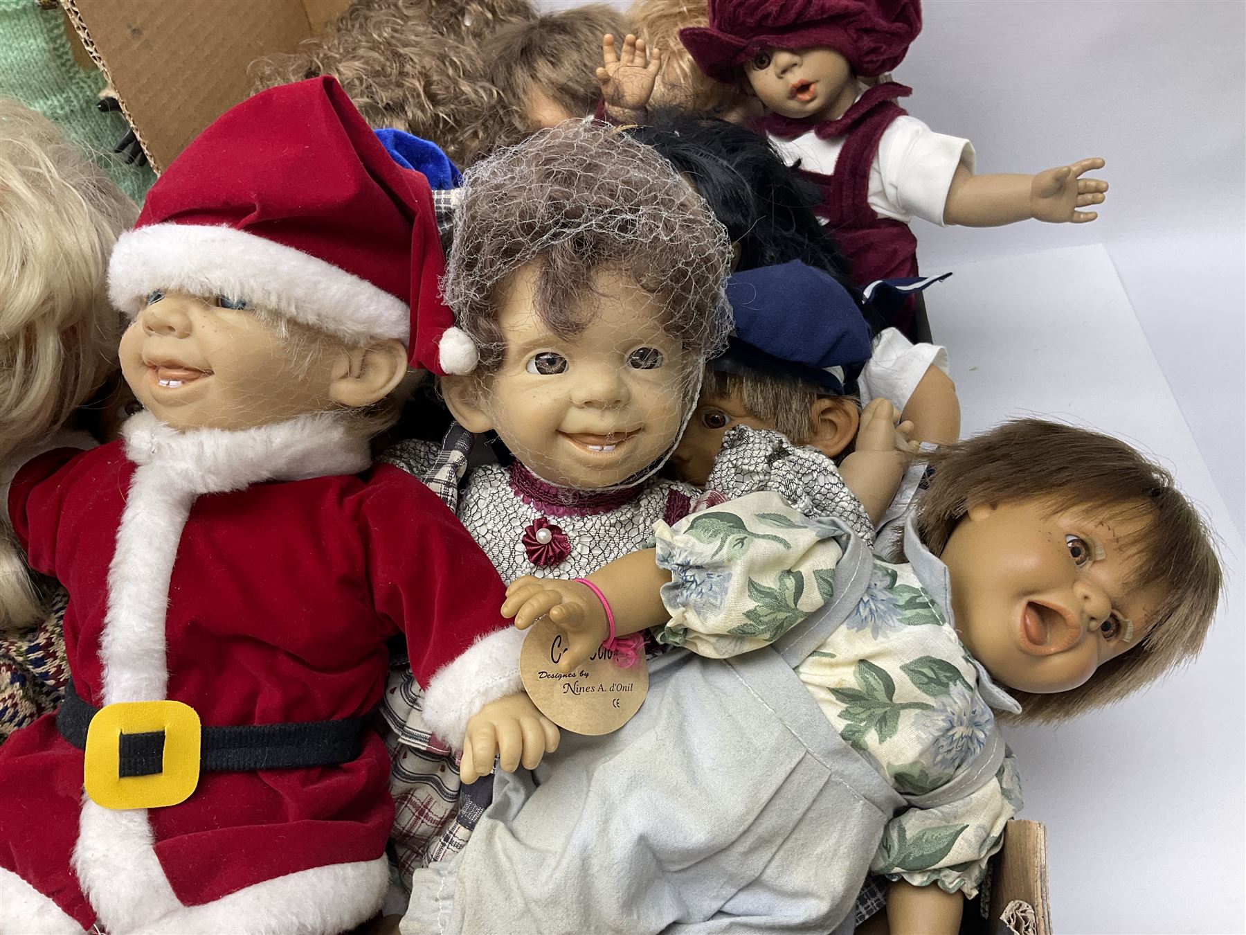 Quantity of vintage and later dolls to include unusual three faced example and further dolls marked C.J, Gloobee, Rosebud etc in three boxes