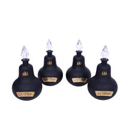 Set of four 20th century Royal Pharmaceutical Society black frosted glass bottles, of bellied form with clear cut glass spire stopper, each body bearing gilt label in Latin: LIN:AMMON:, LIN:ATROP:, LIN:CAMPH:, and LIN:CALCi:, and gilt Royal Pharmaceutical Society crest to neck, H25cm

Provenance: From the collection of the family of Peter Green, a practising pharmacist whose career spanned the mid to late 20th century. During his professional life he managed pharmacies in Yeovil, Somerset, and later Selles Chemist in Filey, North Yorkshire, before purchasing and running his own business, Peter Green Pharmacy, located in the Market Place, Malton. The bottles were displayed as part of the traditional shop fittings in both the Filey and Malton pharmacies and were retained as part of his collection.