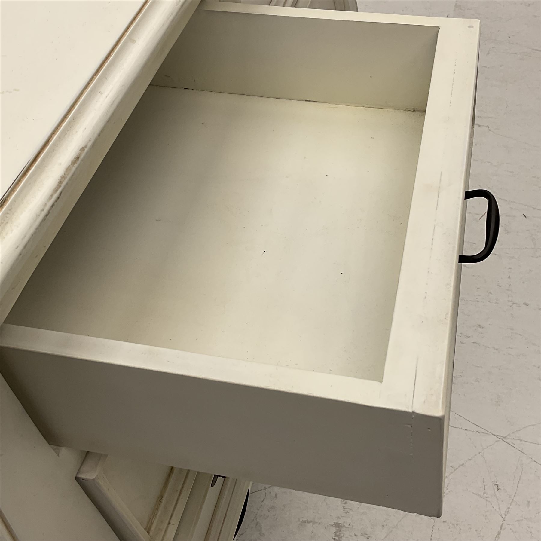 French design bombe shaped chest, moulded rectangular top over two short and three long drawers, on scrolled feet, in cream paint finish 