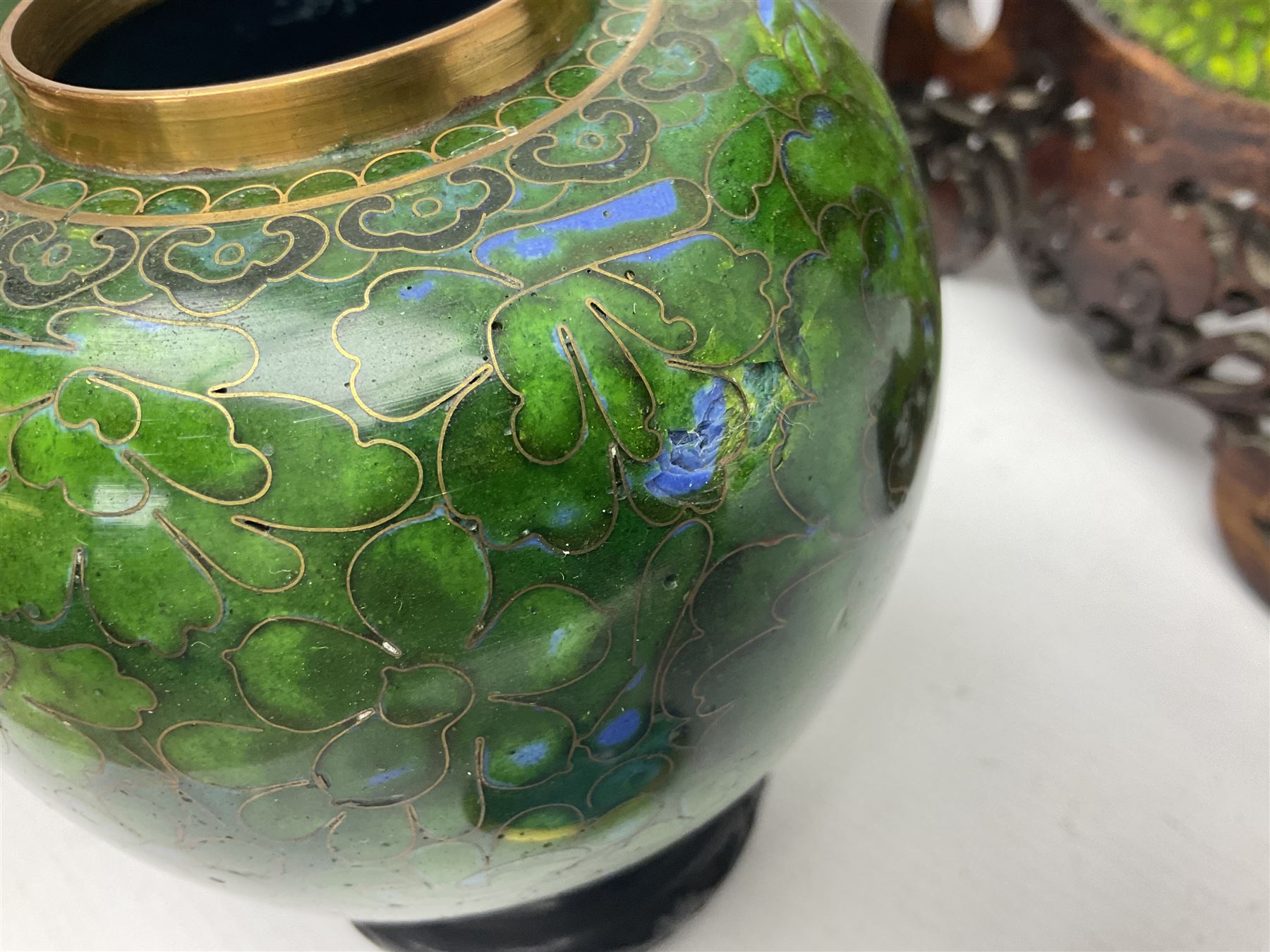 Pair of modern cloisonne ginger jars having floral decoration with a green ground, with hardwood stands, together with a similar plate and a bowl decorated with birds and flowers  