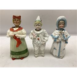 Five Victorian and later nodding figures, including a clown and women in  bonnet and shawl holding a dog, largest example H20cm