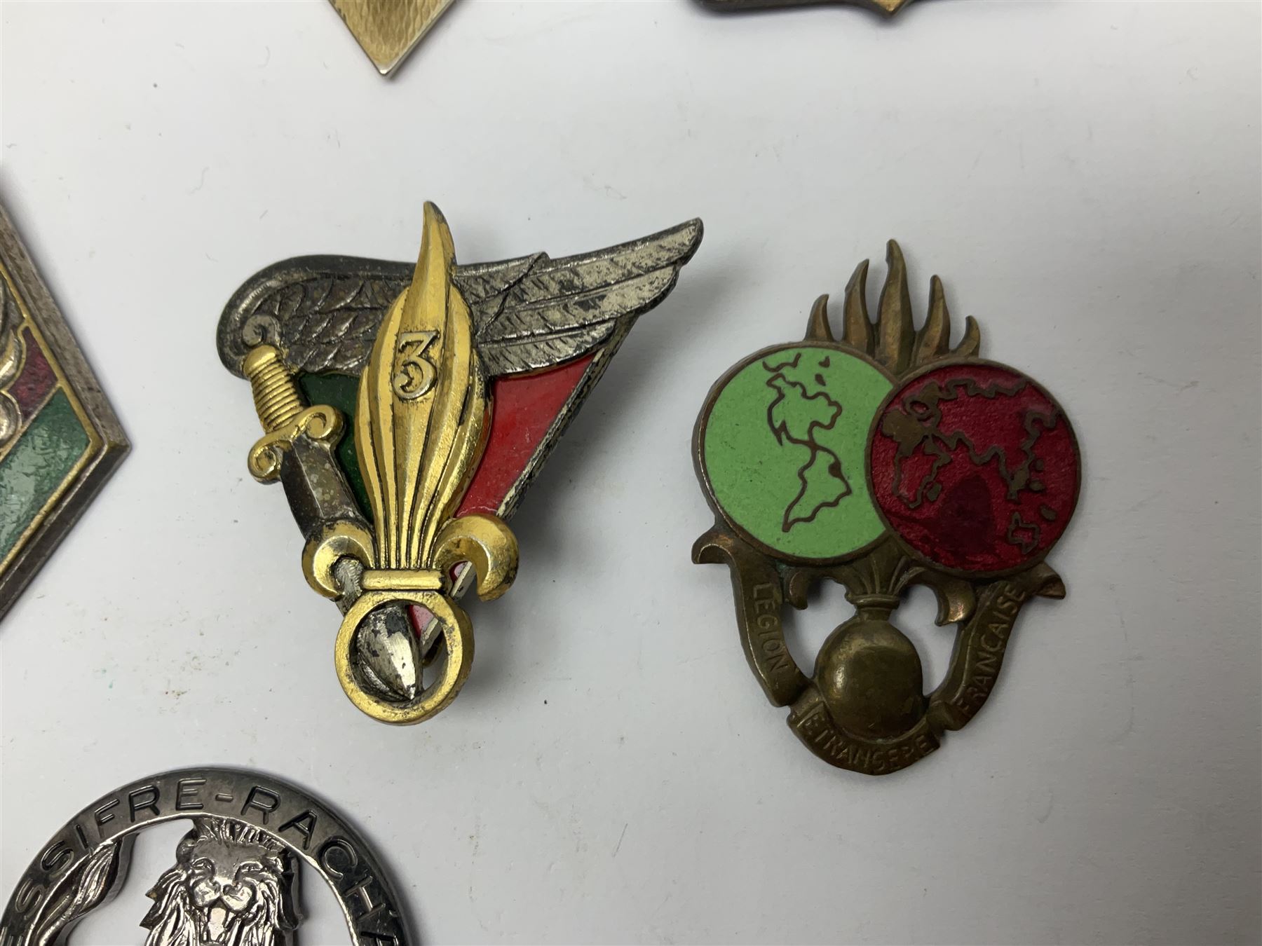 Eleven French Foreign Legion badges including various para, infantry and artillery (some copies)