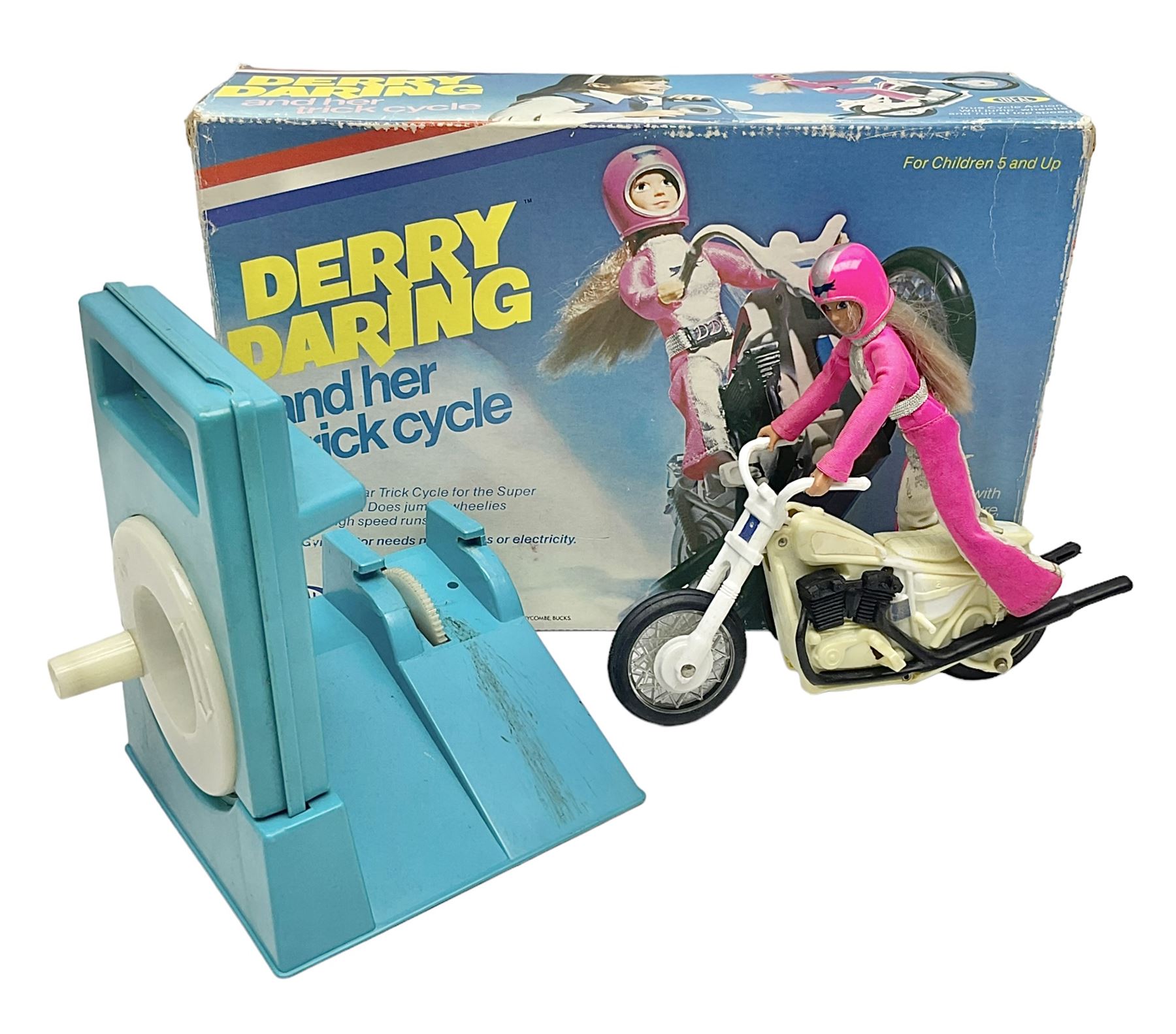 Ideal Derry Daring and Her Trick Cycle, with clothed figure on trick cycle and winder; in original illustrated box dated 1975
