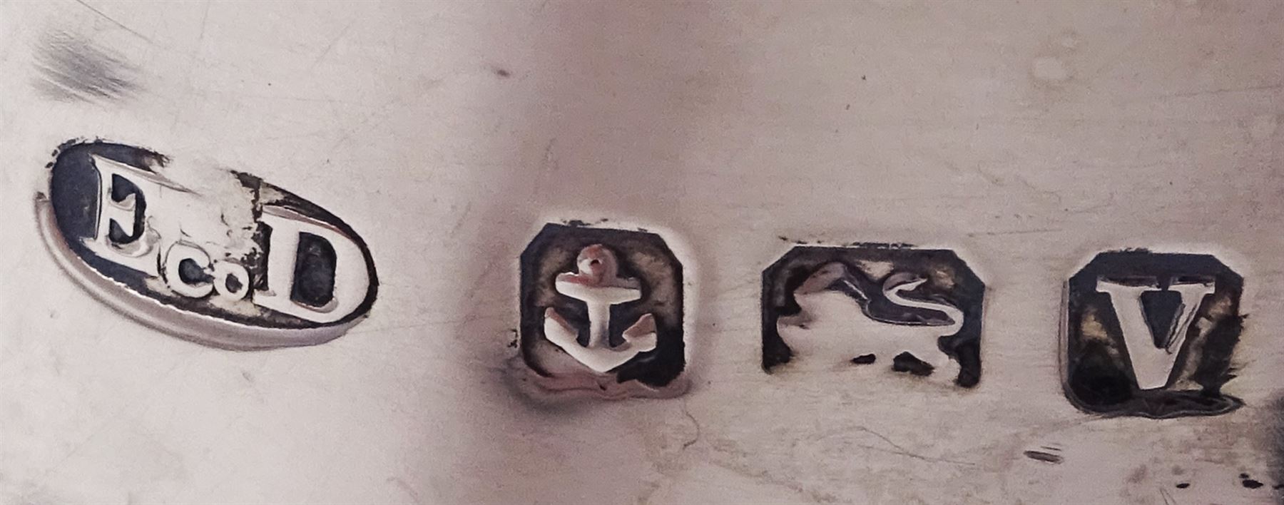 1920s silver hot water pot, of part fluted baluster form, with gadrooned girdle and rim and ebonised handle and finial, upon four bun feet, hallmarked Ernest Druiff & Co, Birmingham 1920