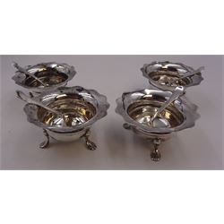 Set of four Edwardian silver open salts, of circular form, each with later personal engraving to scalloped rim and upon three pad feet, together with four matching silver salt spoons, hallmarked James Deakin & Sons, Sheffield 1909, in velvet and silk lined fitted case     