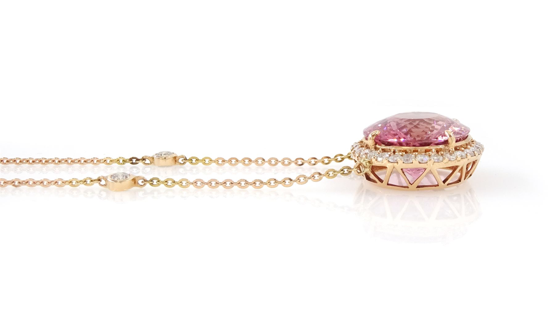 18ct rose gold pink tourmaline and diamond pendant necklace, oval cut tourmaline of 15.41 carat, surrounded by round brilliant cut diamonds, to a trace link chain necklace set with four diamonds, stamped 750, total diamond weight 1.22 carat, with World Gemological Institute report
