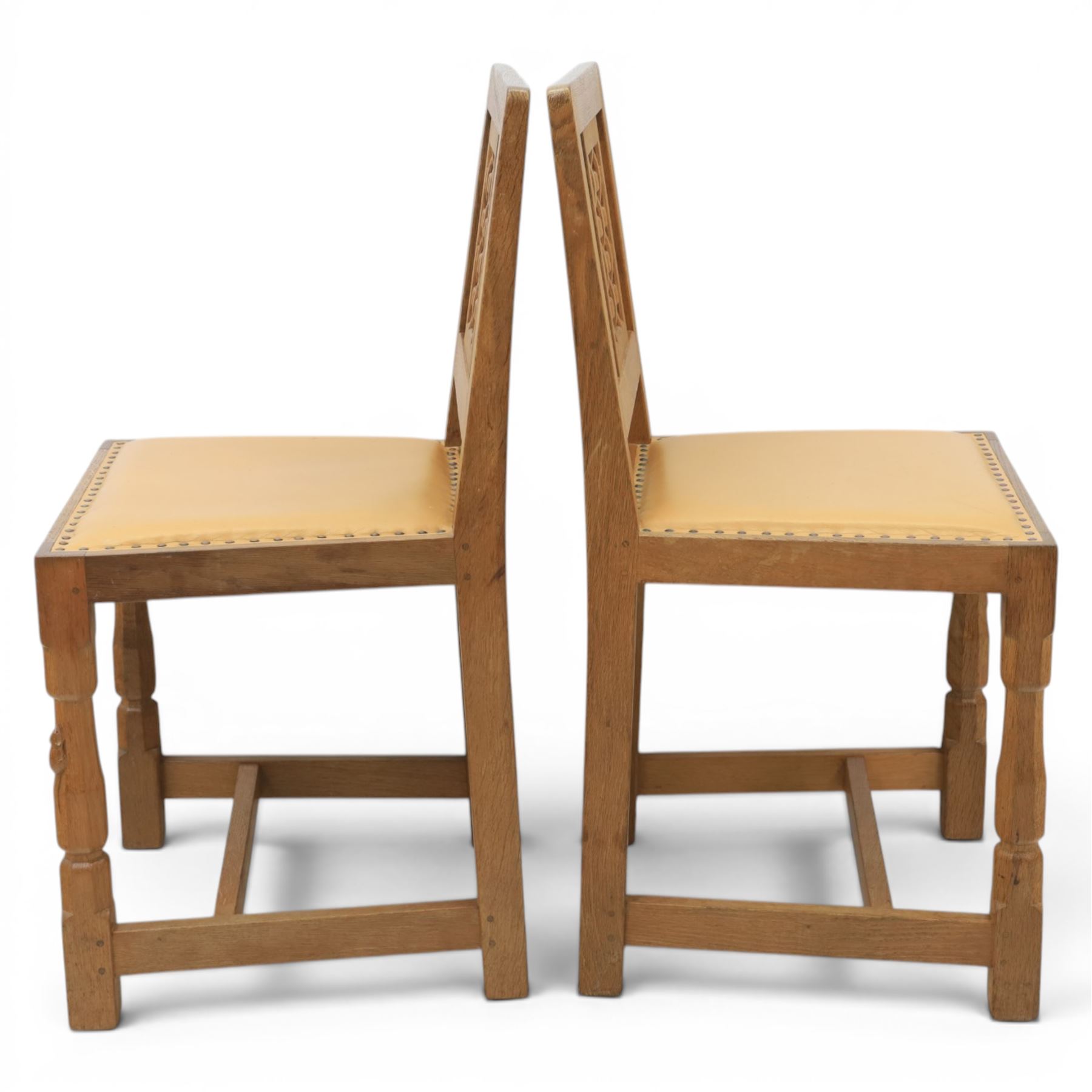 Mouseman - set of four oak lattice back chairs with tan seat with brass studded trim, with carved mouse signature, by the workshop of Robert Thompson of Kilburn