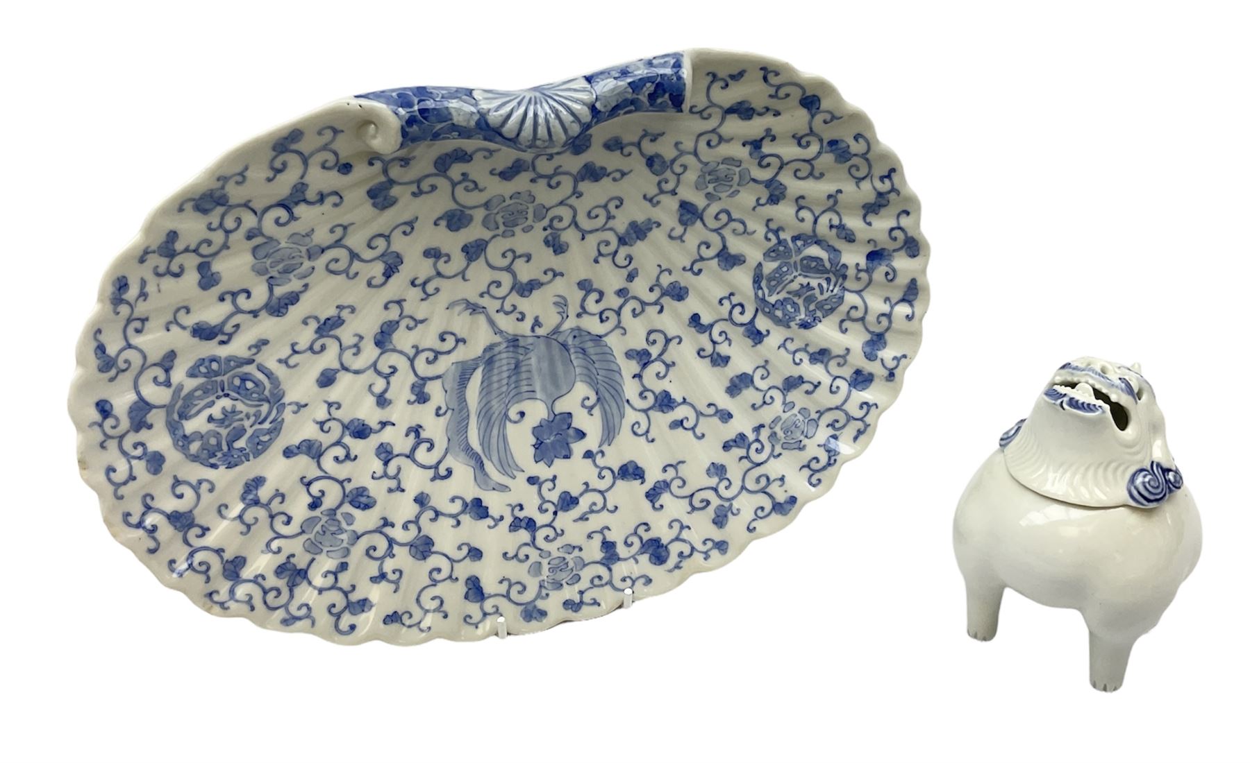 Japanese Hirado blue and white porcelain censer in the form of a Lion Dog, together with a Hirado porcelain shell shaped dish, centrally decorated with an exotic bird flanked by two roundels on floral scroll ground, censer H13cm