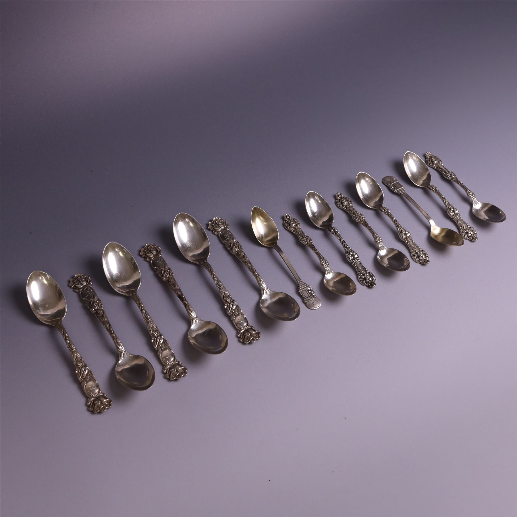 American silver tea and coffee spoons, comprising set of six coffee spoons with embossed lily decoration, set of six teaspoons with embossed rose decoration, both with engraved initials and a pair of Larkin coffee spoons, all stamped Sterling