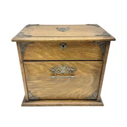 Edwardian oak correspondence box, the hinged lid enclosing an fitted interior with compartments for a calendar, inkwells and pens, the fall front enclosing envelope storage, H28cm