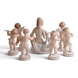 Seven Wallendorf figures, including Young woman with deer 1754, four putti with musical instruments and two cherubs, H18cm