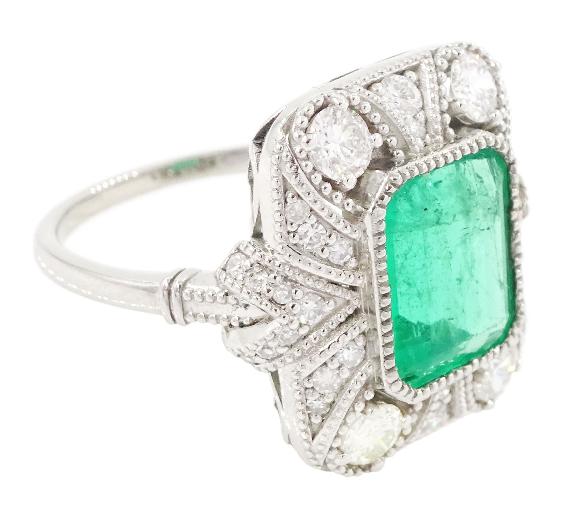 Platinum emerald and diamond cluster ring, single octagonal cut emerald of 2.52 carat, surrounded by milgrain set round brilliant cut and single cut diamonds, stamped PT950, total diamond weight 0.82 carat