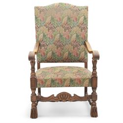 Early 20th-century Jacobean revival open oak armchair, arched padded back, and seat button upholstered  in foliate tapestry style fabric, with scroll carved arms on turned supports, raised on block supports united by turned shaped stretchers 