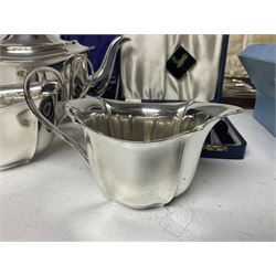 Silver plated three piece tea service, comprising teapot, milk jug and sugar bowl, together with a set of four Wedgwood silver plated heart shaped place card holders and a collection of silver plated cased cutlery