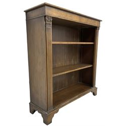 Georgian design walnut open bookcase, fluted uprights with acanthus carved capitals enclosing two adjustable shelves, on bracket feet