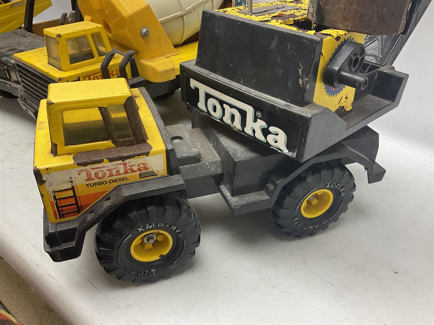 Tonka - five large scale pressed steel vehicles comprising Cement Mixer, Mighty Mobile Crane, Jeep and two Dumper Trucks (5)