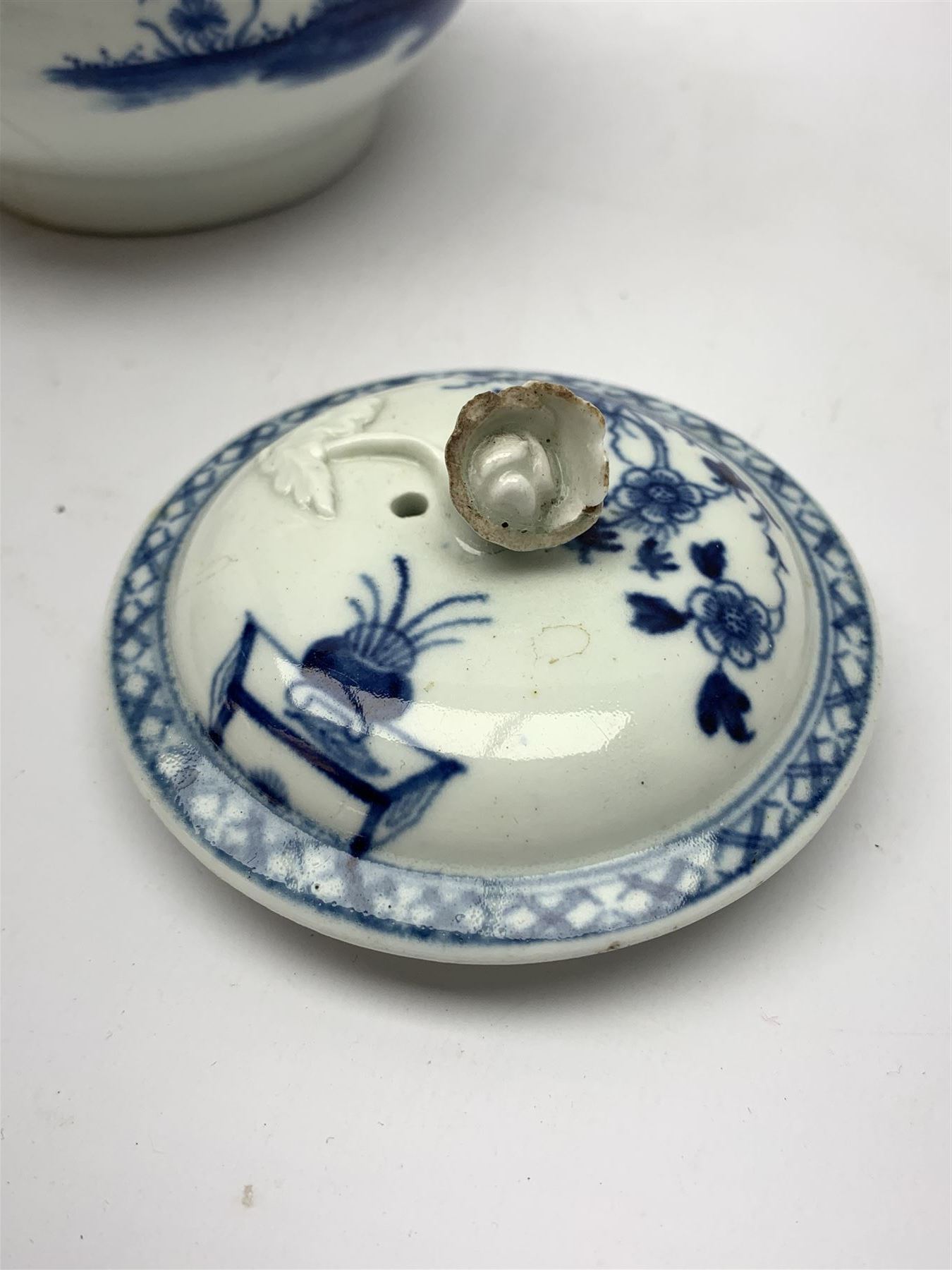 18th Century Worcester teapot, circa 1765-70, decorated in the Bird in the ring pattern, the cover with bud finial, with crescent mark beneath, H13cm, together with a Worcester coffee cup decorated in the same pattern, with crescent mark beneath, H6.5cm