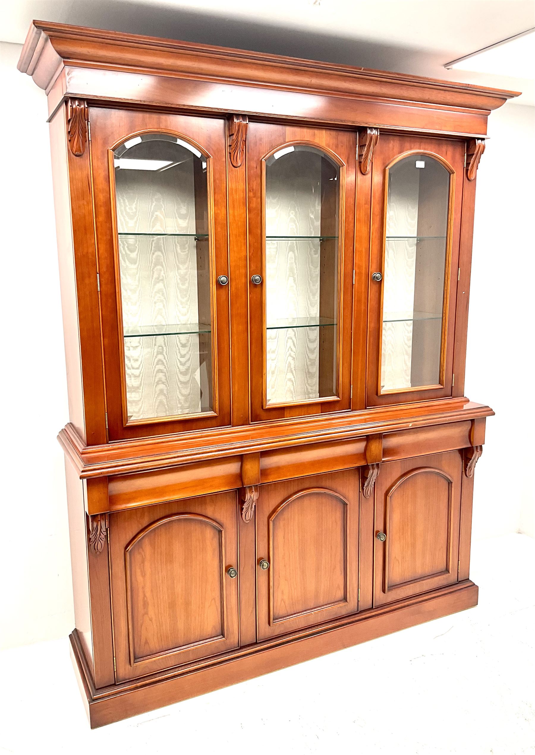 Waring & Gillow three door bookcase on cupboard, illuminated interior