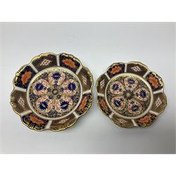 Two Royal Crown Derby Goldfinch Nesting paperweights with silver stoppers, together with two Royal Crown Derby imari pin dishes, largest dish D13cm