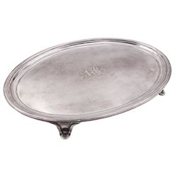 George IV silver card waiter or tray, of oval form with reeded rim and engraved monogram to centre, upon four splayed feet, hallmarked John Mewburn, London 1822, W26cm, approximate weight 15.74 ozt (489.4 grams)