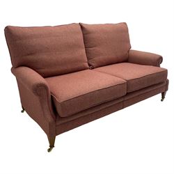 Edwardian design grande two-seat sofa, upholstered in wool herringbone rouge fabric, rolled arms, on square tapering supports with brass castors