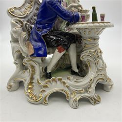 Figure group, probably Volkstedt, modelled as a courting couple seated before a table, the ornate bench and table conforming with and leading from the gilt heightened scrolling base, with blue painted mark beneath, H14.5cm
