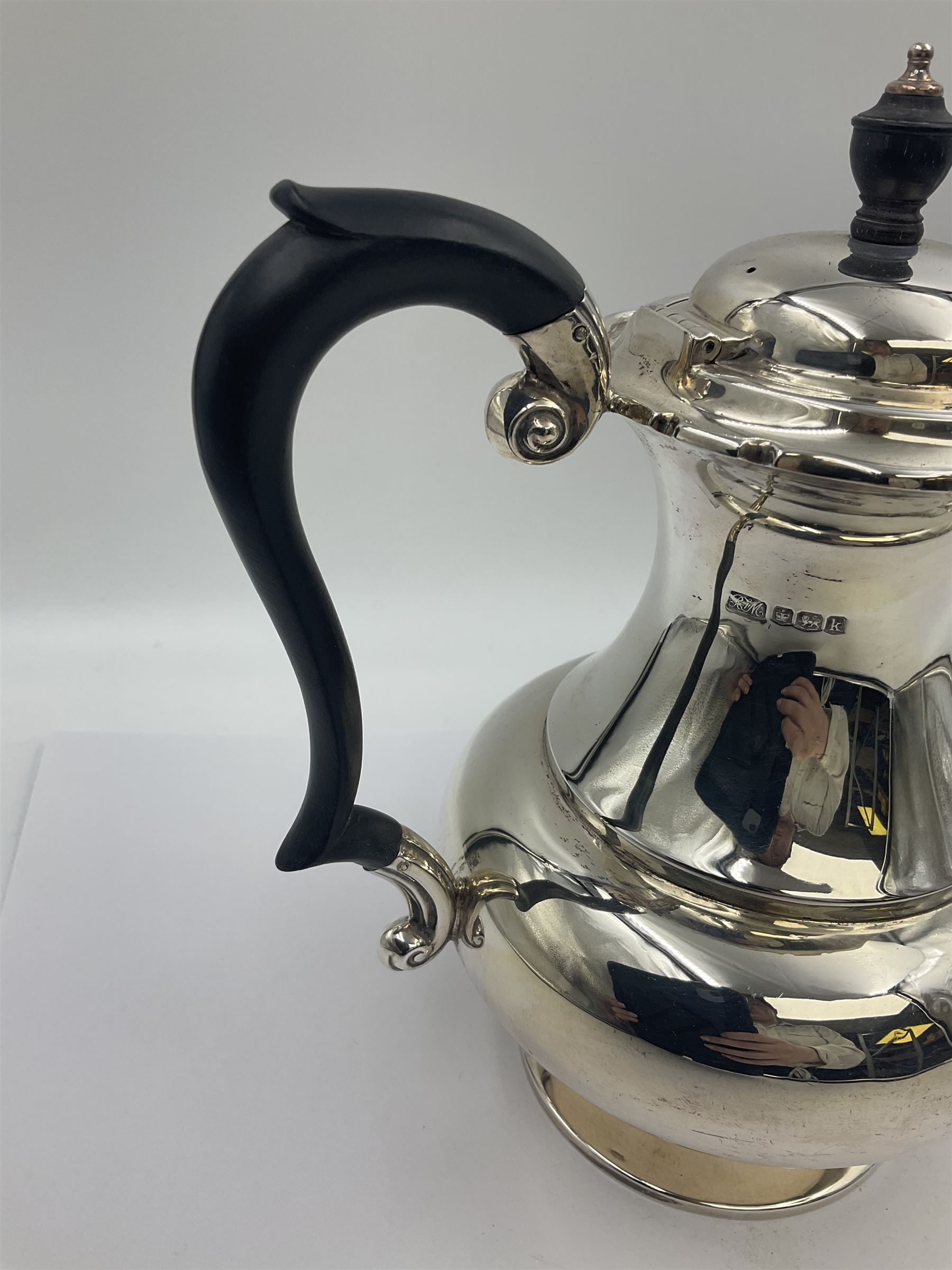 1920s five-piece silver tea service, comprising teapot, coffee pot, hot water pot, twin handled open sucrier and milk jug, each of squat circular form with shaped rim, the teapot, coffee pot and hot water pot each with ebonised handle and finial, the sucrier and milk jug with acanthus capped scroll handles, all upon circular foot, hallmarked R F Mosley & Co, Sheffield 1926 & 1927, tallest H24cm