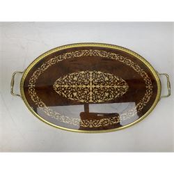 Ornate gilt oval mirror, maroon table lamp of baluster form decorated with foliage with floral shade, and an inlaid wood oval serving tray