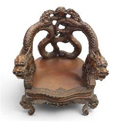 Chinese carved hardwood dragon throne chair, the shaped and pierced back with entwined dragons and cloud motifs, sweeping dragon-form arms terminating in carved heads, solid panel seat over foliate carved apron, on four mask carved cabriole supports