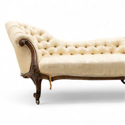 Late 19th century Victorian walnut button-back recamier, asymmetrical form, with cream damask fabric and gimp braid edging, shaped reeded apron above front and back scroll carved cabriole legs on brass castors