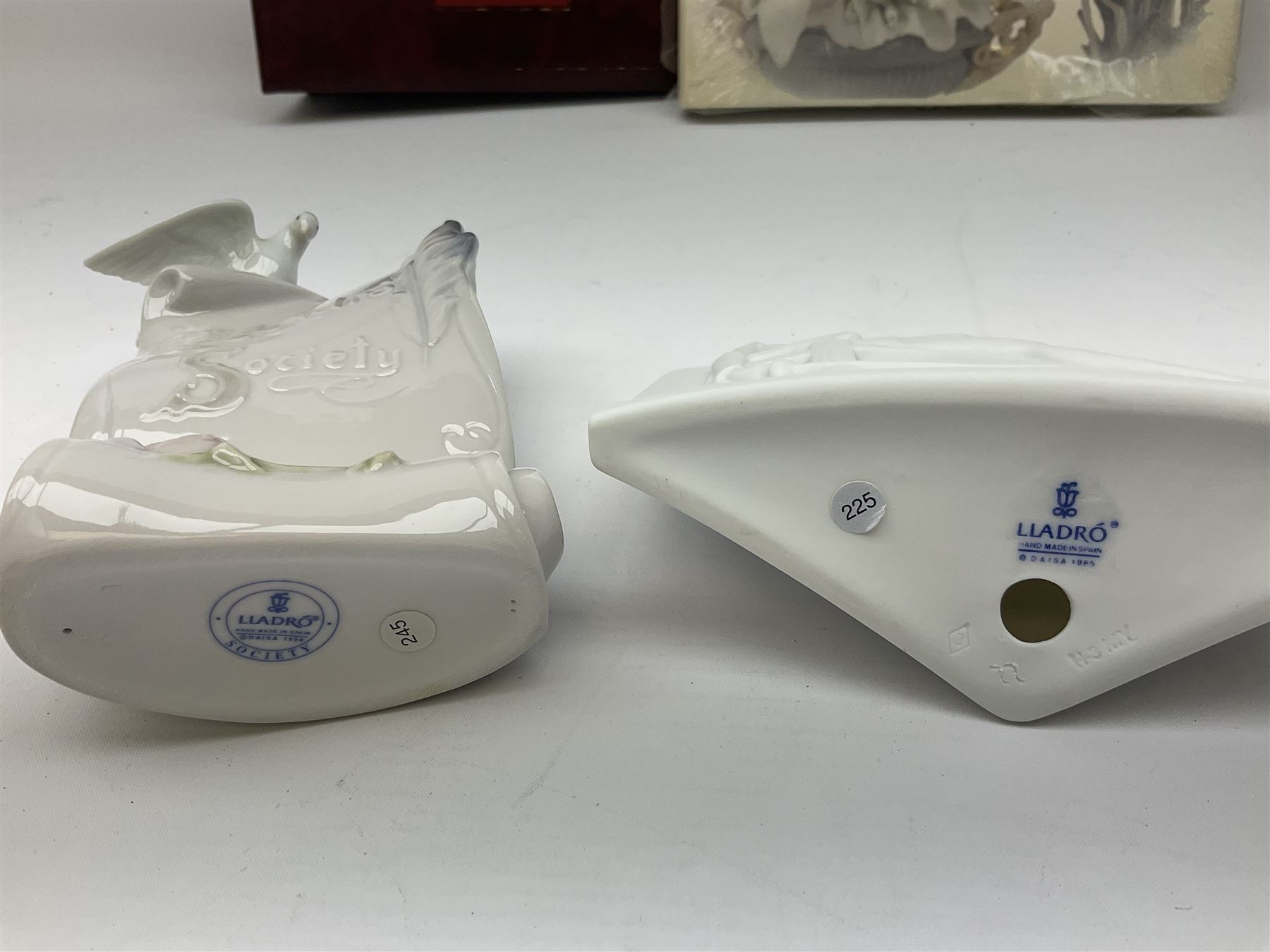 Lladro Collectors Society items, comprising of The Will to Create book, two candle holders; Sailing the Sea no 17665, Dolphins at Play no 17666, Plaque Bringing Us Together, key fob, leather wallet and a members joining pack with plaque, all in original boxes  