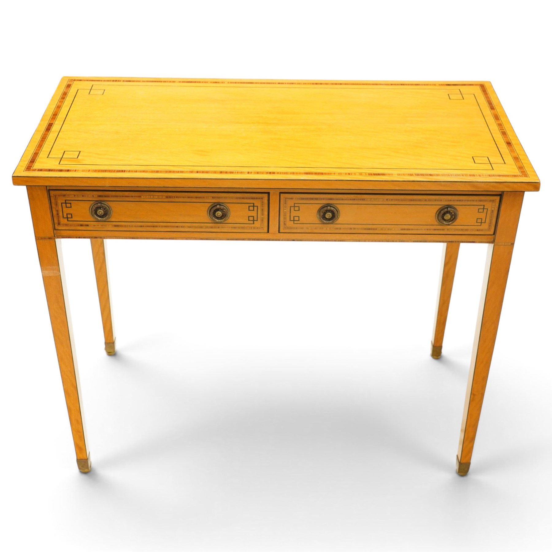Pair of George III design inlaid satinwood console or side tables, rectangular top with mahogany cross-banding and ebony stringing, fitted with two drawers with brass ring handles, on square tapering supports with brass cups and castors