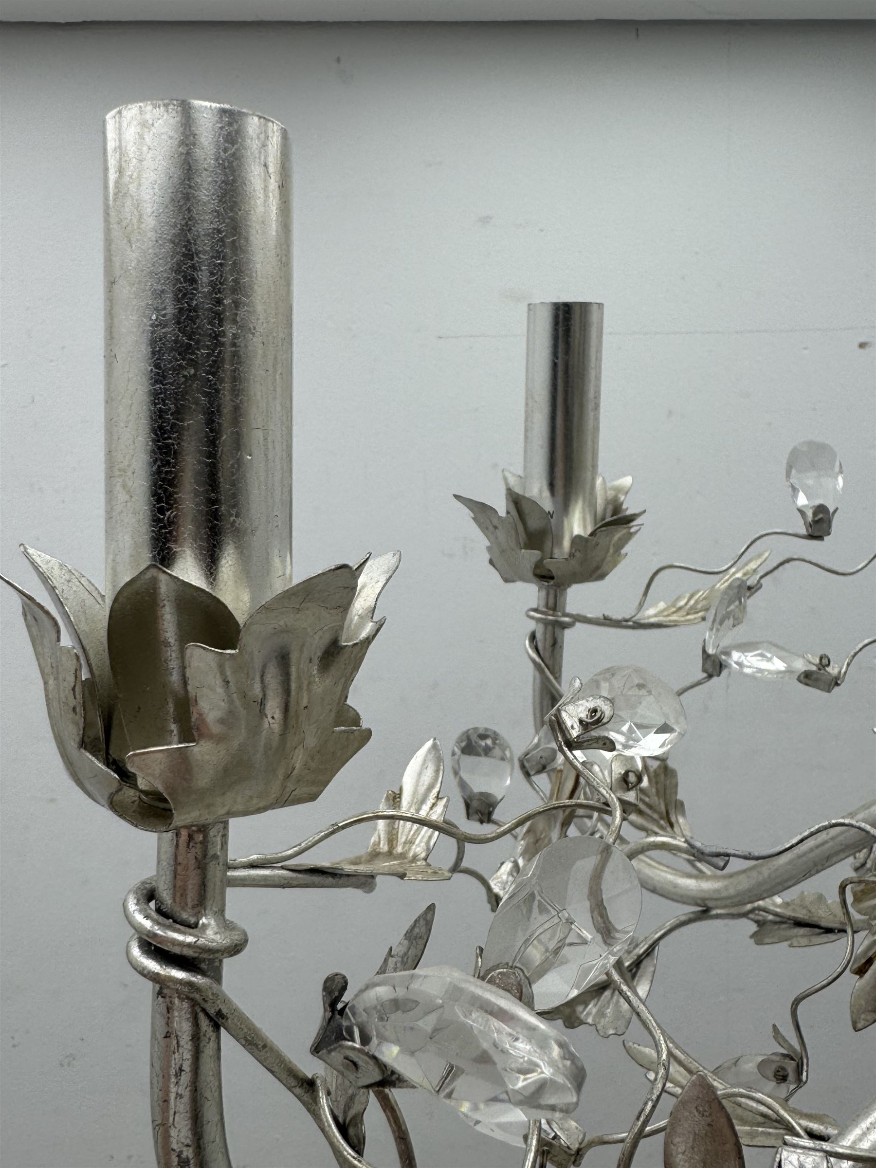 India Jane - silver finish metal chandelier, modelled with scrolling vines and leaves, embellished with faceted glass drops, fitted with six candle sconces, and wired for electricity