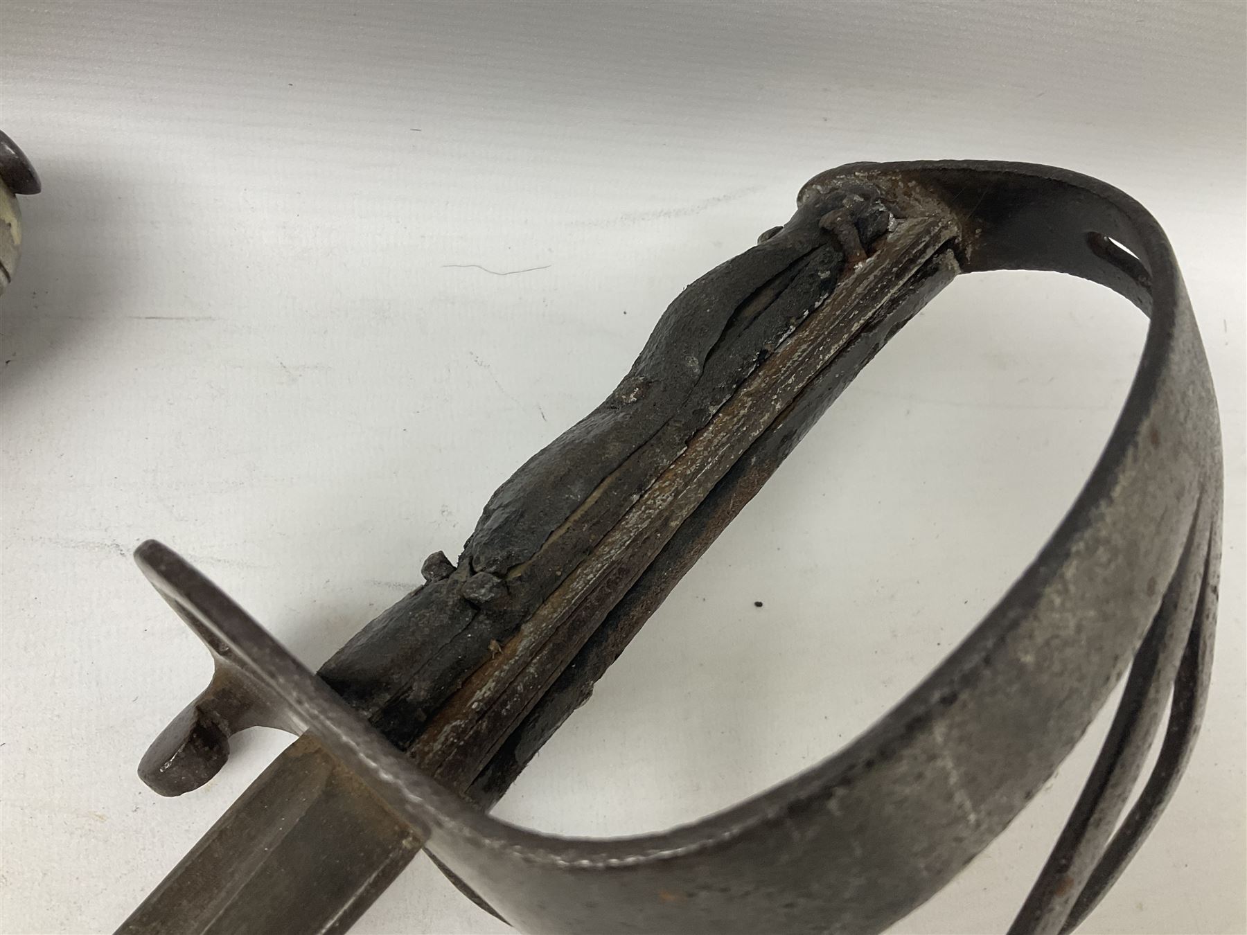 George V British Army 1897 pattern officers sword with plain 82cm fullered steel blade, pierced  basket hilt with George V cypher and wire bound leather grip with chequered backstrap; in leather covered field service scabbard L101cm overall; and another officer's sword in relic condition lacking scabbard (2)