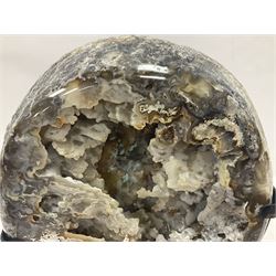 Large agate geode with quartz crystals to the centre, upon a metal stand, H35cm 