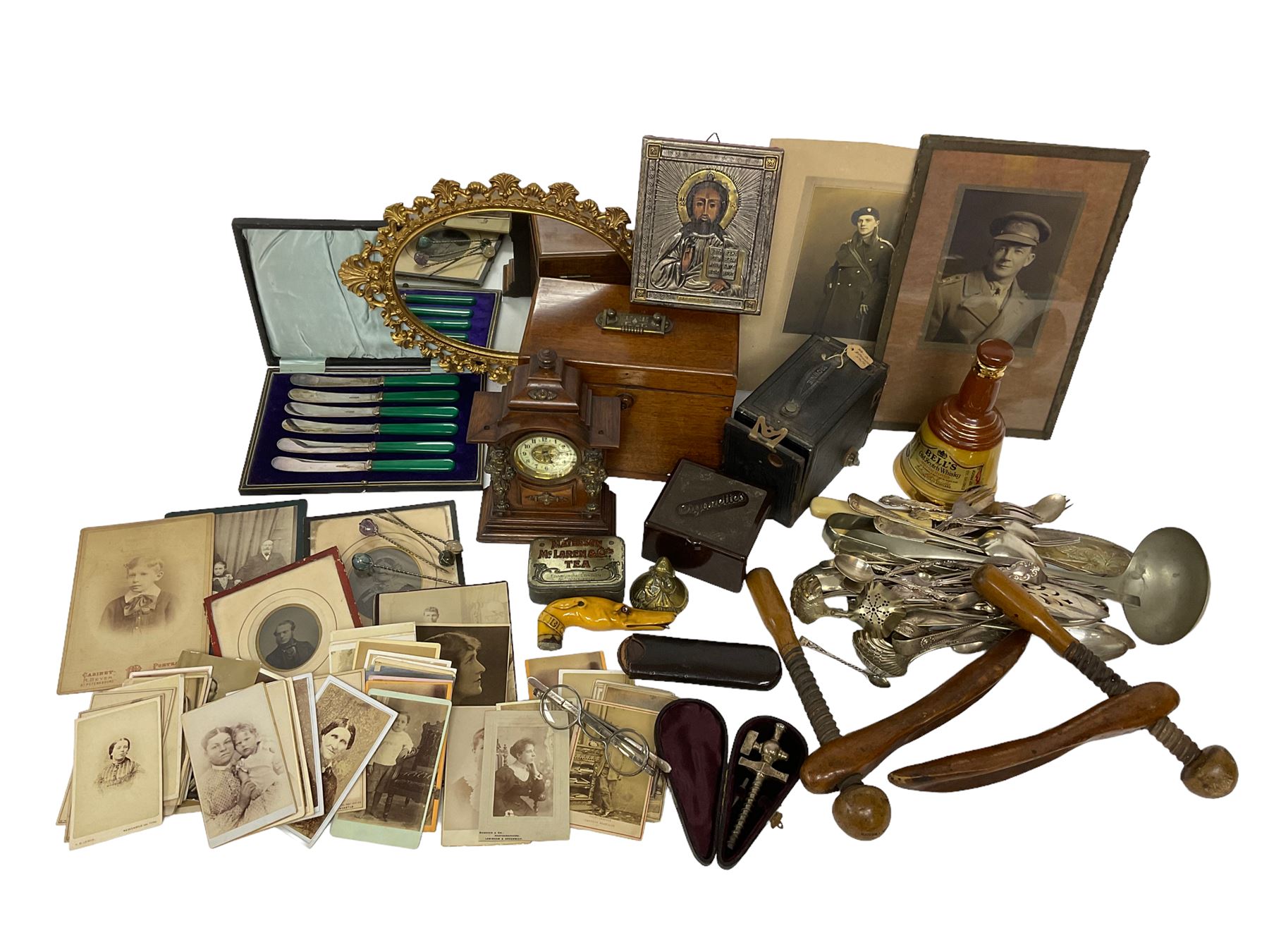 Quantity of mid 19th century and later photographs to include cartes des visites,  together with a small oval mirror, early 20th century clock, Bakelite cigarettes box, three hallmarked silver spoons, pair of Georgian spectacles with extending arms, silver and gold Plated reproduction icon, other silver plate and metal ware etc