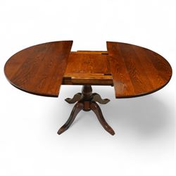 Late 20th century oak extending dining table, circular top with moulded edge, centre split revealing an additional leaf, on turned column support with four downswept legs (Extends to 165cm)