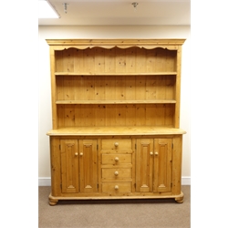 Waxed pine traditional dresser with raised two tier plate rack, projecting cornice, four drawers flanked by cupboards, bun feet, W171cm, H201cm  