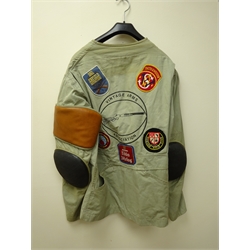  Lightweight shooting jacket, padded right shoulder and elbows, with Vintage Rifle Association decal and various shooting related patches, and a fingerless leather shooting glove (2)  