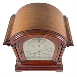 Gustav Becker, German 20th century 8-day mahogany cased mantle clock, break arch mahogany case with a round topped door flanked by reeded pilaster with Ionic capitals and raised on a stepped plinth, the dial with engraved Roman numerals, with steel fleur di Lis hands, and  chime /silent dial, H43cm