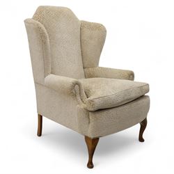 Late 20th century wingback armchair, upholstered in beige embossed fabric with brass stud ...