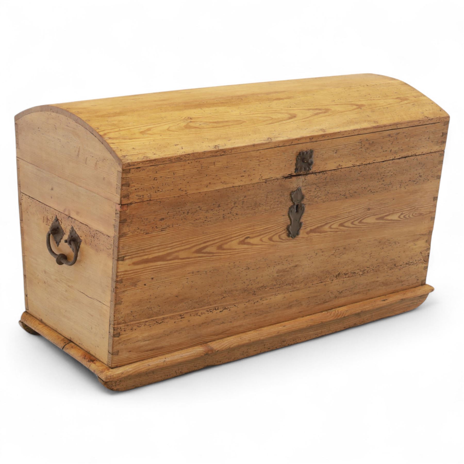 Early 20th century pine coffer, domed lid over plain front and sides with exposed dovetail joints, iron hasp and staple to front