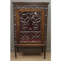  Early 20th century oak display cabinet, projecting cornice with dentil detailing, gothic style carvings, two glass shelves, square tapering supports, W90cm, H149cm, D43cm   