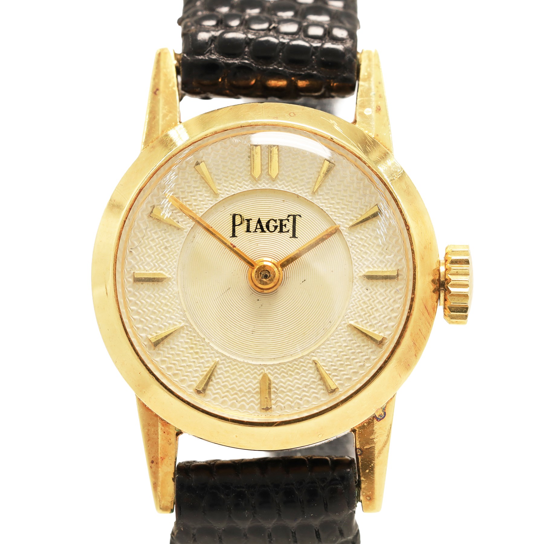 Piaget ladies 18ct gold manual wind wristwatch, silvered / champagne engine turned dial with dagger hour markers, back case No. 5635, Birmingham import mark 1956 with Helvetia hallmark, on black leather strap