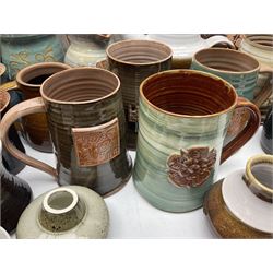 Wold studio pottery tankards, in various colours and relief decoration together with other studio items including vases, jugs and pots 