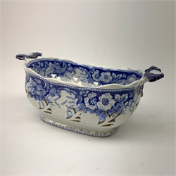 Mid 19th century blue and white transfer printed pearlware reticulated chestnut basket, of oval form with twin handles, decorated to the interior with figures before a classical temple within a garden setting, including handles W26cm, together with a mid 19th century blue and white transfer printed pearlware stand with reticulated edge, decorated with a Willow Pattern, L25cm, and a John and William Ridgeway blue and white transfer printed twin handled pierced basket, decorated with a pastoral scene containing figures at work, with printed mark beneath, including handles L25cm