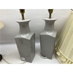 Pair of grey ceramic table lamps, together with another lamp on a wooden plinth and three lampshades