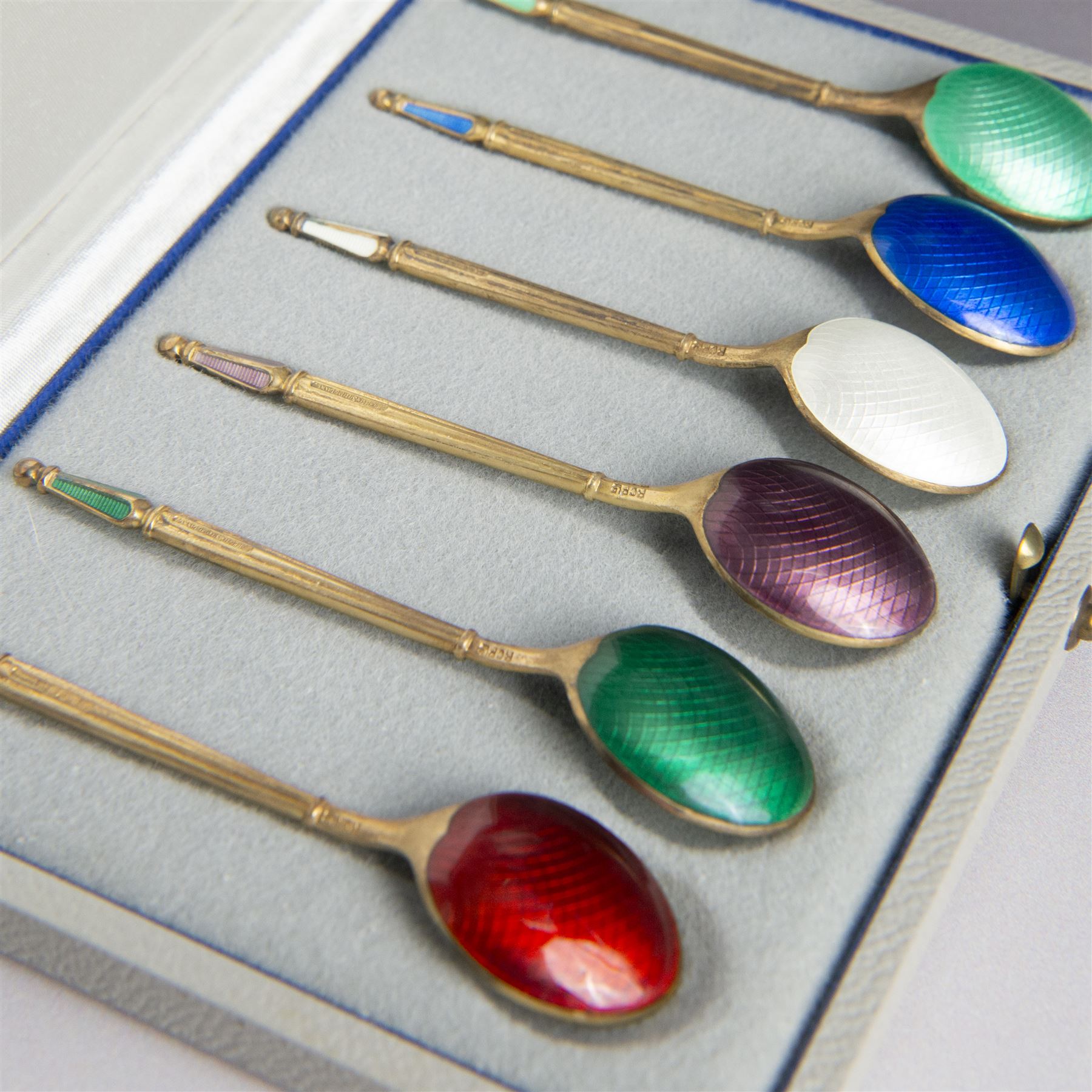 Set of six Danish silver-gilt and guilloche enamel demitasse spoons by Anton Michelsen, stamped A. Michelsen, Sterling, Denmark, with import marks for London, R C P Ltd, in fitted case