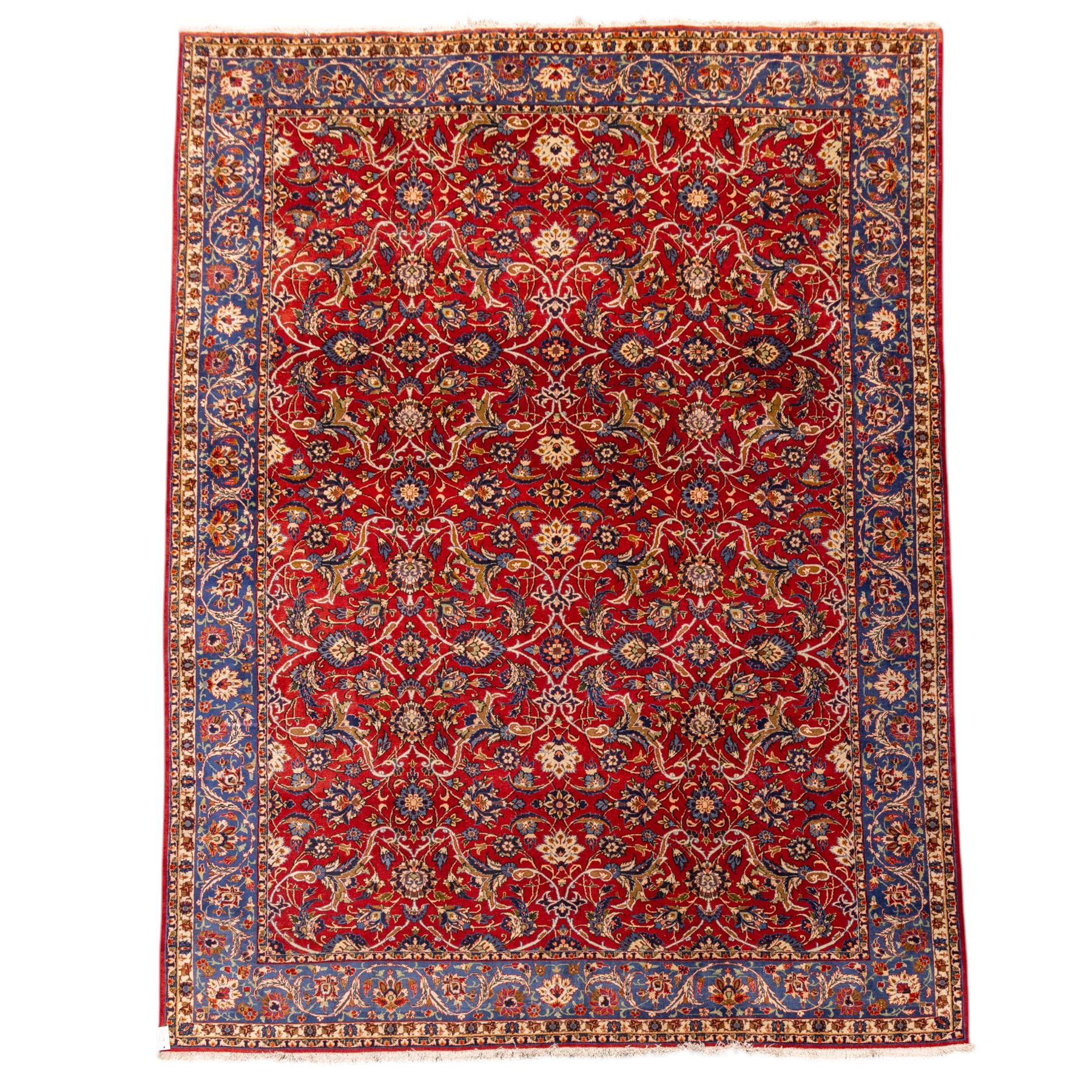 Central Persian Markazi Mahal hand-knotted carpet, terracotta red field, with an all-over scrolling vine design issuing with palmettes, rosettes, and serrated leaves, linked by ivory vinery, deep cobalt blue main border with floral ornamentation, flanked  by multiple guard stripes of repeating geometric motifs, with cotton fringe ends