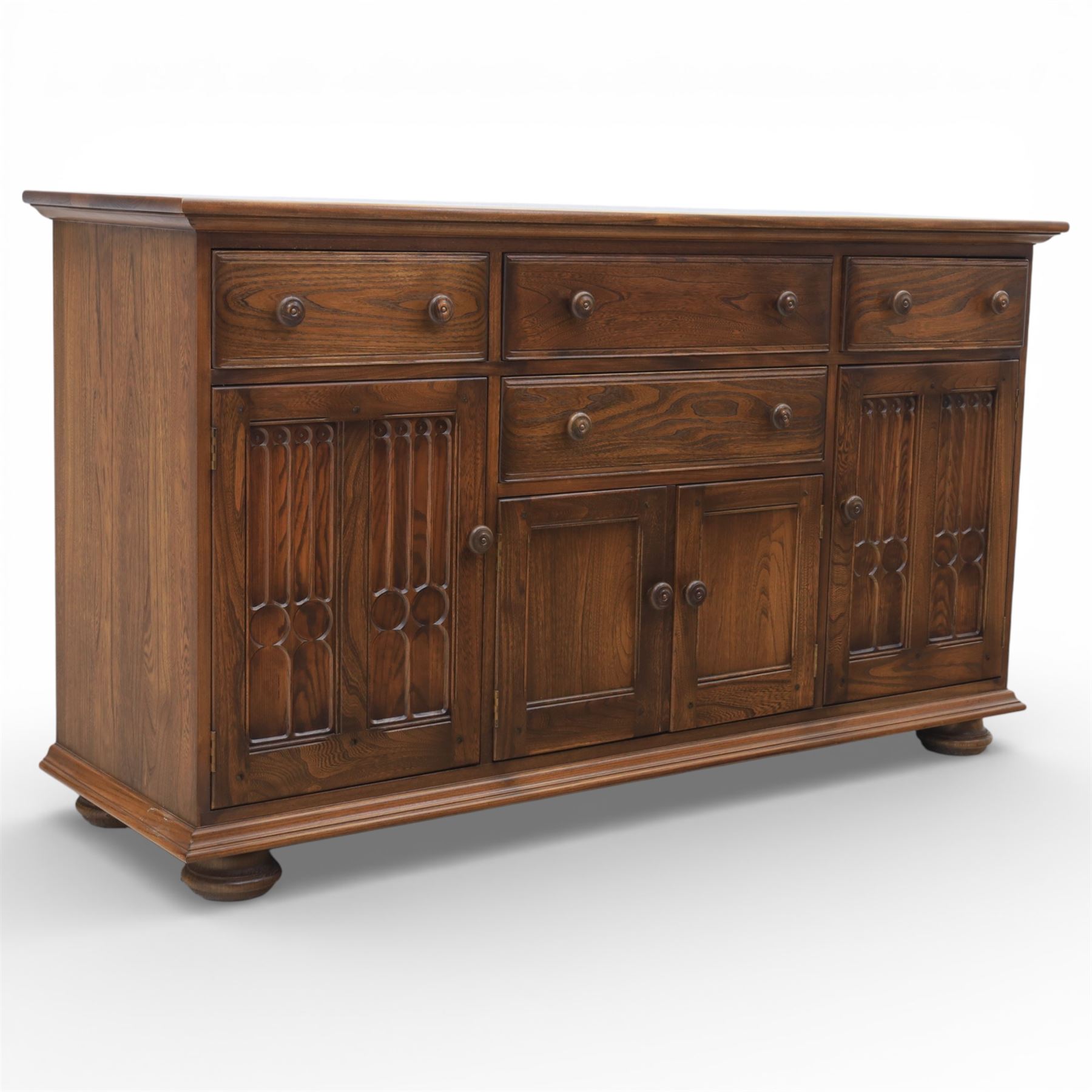 Ercol - elm dresser sideboard, fitted with four drawers and four cupboards with carved detail, drawer featuring cutlery slide